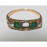 An emerald and diamond ring (one stone deficient)