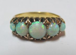 A gold coloured five stone opal ring, size L