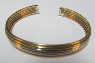 A yellow metal two colour bangle bracelet