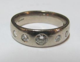 A diamond gypsy style ring marked 750, size V/W 11.2g