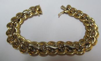 A yellow metal bracelet marked 750