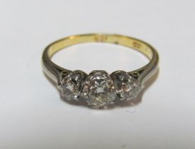 An 18ct three stone diamond ring, size M 2.2g