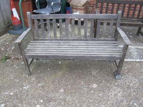 A slatted garden bench with wheels one end