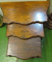 A nest of three walnut tables