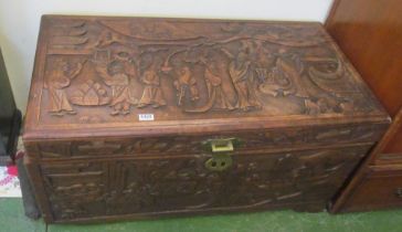 An oriental camphorwood chest carved figures