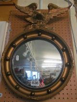 A convex gilt mirror with eagle surmount