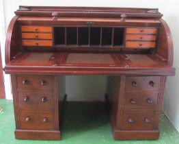 A large mahogany roll top desk with fitted interior