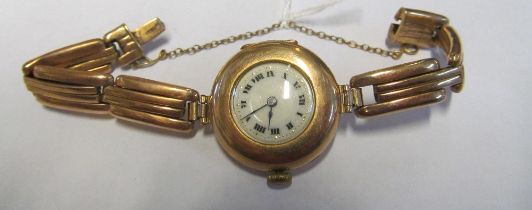 A 9ct gold ladies watch with 9ct gold strap (21.4g all in)