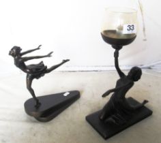 An Art Deco style resin lady holding a candle and another lady running