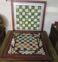 A decorative chessboard on feet and another heavy chessboard