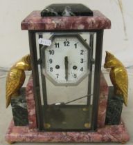 An onyx clock cockatoos to the side