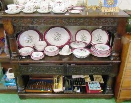 A carved oak three tier buffet