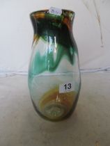 A tall glass vase with green and brown swirl pattern