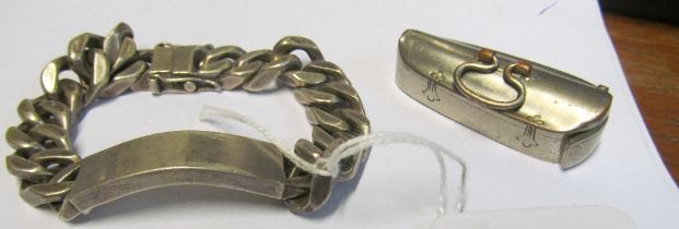 A silver identity bracelet and violin case vesta