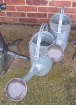 Two metal watering cans