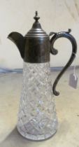 A glass claret jug with silver collar, lid and handle