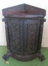 A carved Burmese corner cabinet