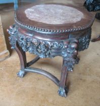 An oriental marble top low table