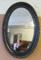 An oval black mirror