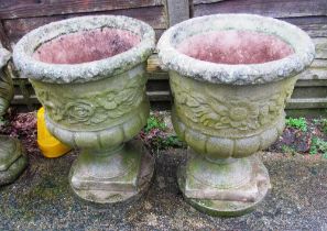 Two concrete plant pots on plinth