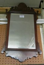 A walnut shaped framed mirror