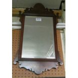 A walnut shaped framed mirror