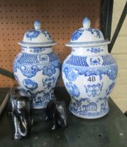 A pair of modern blue and white lidded jars and two elephant ornaments