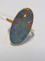 An oval opal ring marked 18k