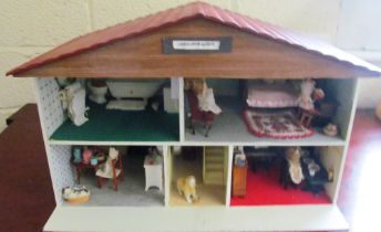 A chalet doll's house complete with furniture and accessories