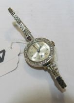 An 18ct gold ladies watch detachable bezel with white stones 9ct gold strap