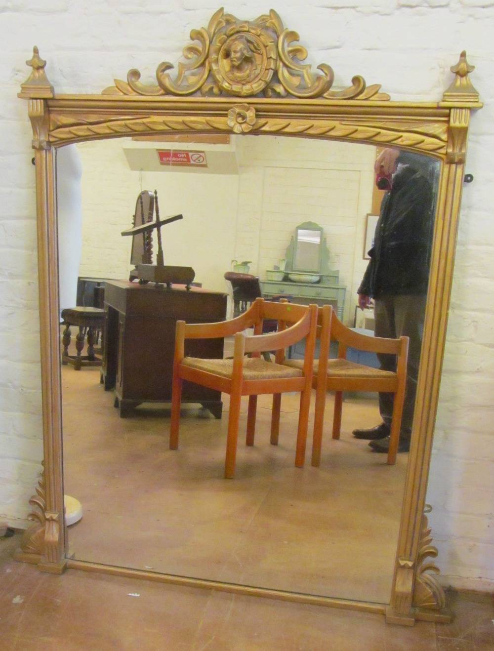 A gilt overmantel mirror