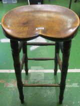 An early 20th Century bar stool on turned legs and shaped seat and another bar stool