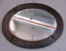 An Arts & Crafts oval copper framed mirror