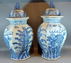 A pair of Chinese large under glaze blue decorated covered vases of octagonal form, decorated with