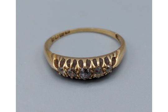 An 18ct gold five stone diamond ring, set with five graduating diamonds within a pierced setting,