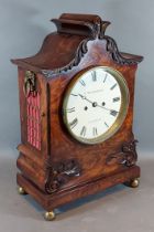 A William IV mahogany case bracket clock, the carved shaped case with side ring handles, the dial