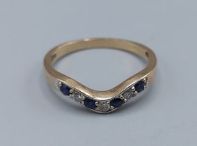 A 9ct gold Sapphire and Diamond eternity ring, set with four Sapphire and three Diamonds, ring