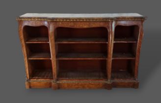 A Victorian walnut, marquetry inlaid and gilt metal mounted bookcase, the moulded top above open