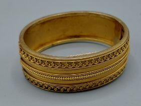 An Edwardian gold bangle, tested, 32gms