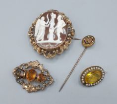 A large oval cameo brooch with pierced scroll frame together with two 19th Century brooches and a