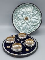 A set of four Victorian silver salts with spoons within a fitted case, London 1893 and 1894, 5ozs