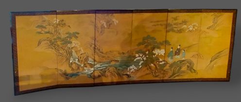 A Chinese six fold screen, hand painted with figures within a landscape, 140cms x 370cms