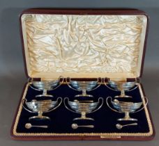 A set of six Edwardian silver salts with spoons within fitted case, London 1905 and 1906, 13ozs