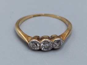 A yellow metal three stone Diamond ring, 2.1gms, ring size M