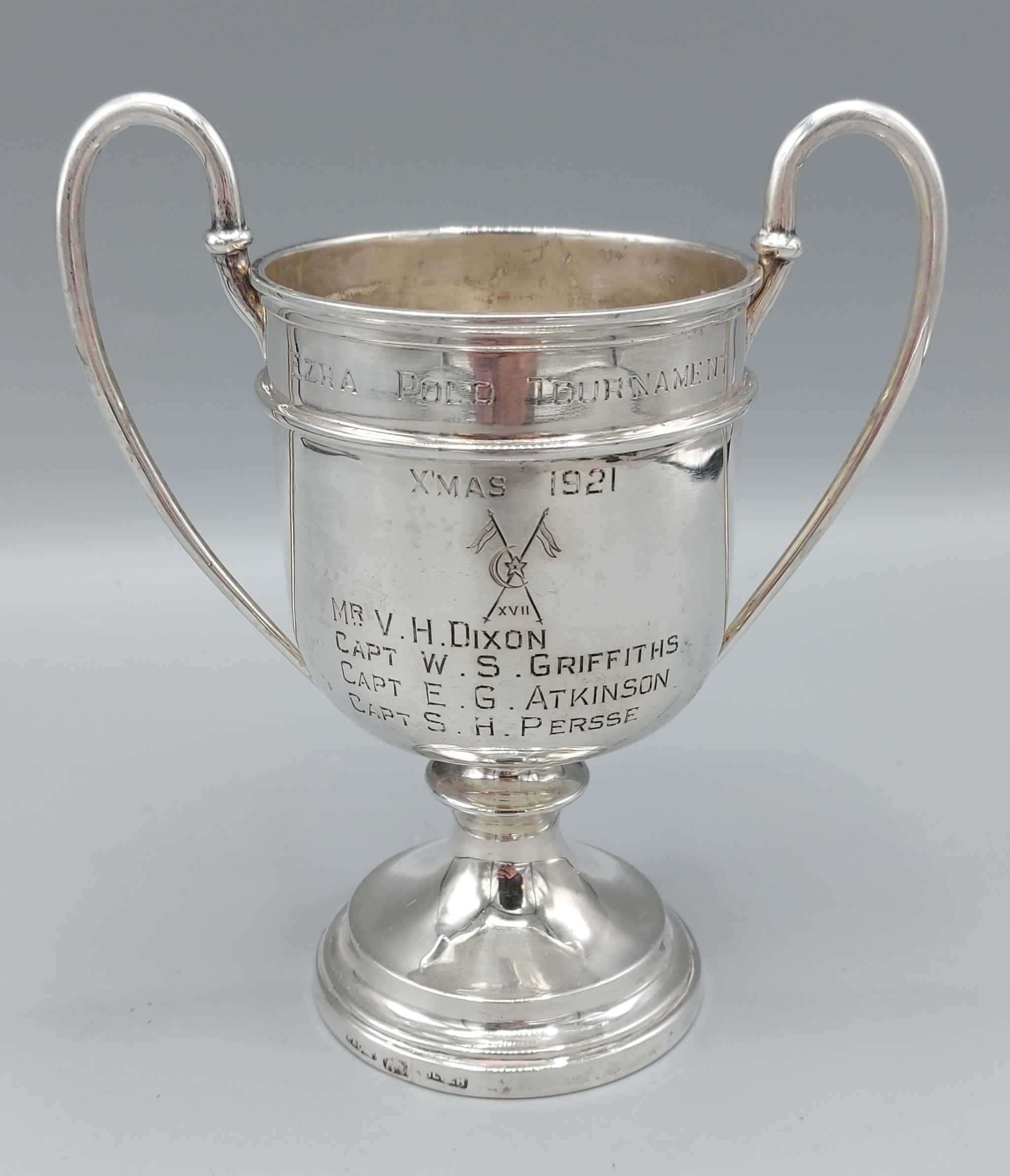 An Indian silver pedestal trophy cup with twin handles, inscribed, Ezra Polo Tournament Xmas 1921,
