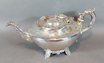 A William IV Scottish silver teapot with shaped handle and spout and with four scroll feet,