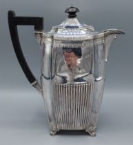 A Victorian silver coffee pot of half lobed form with engraved band and ebonised handle, London