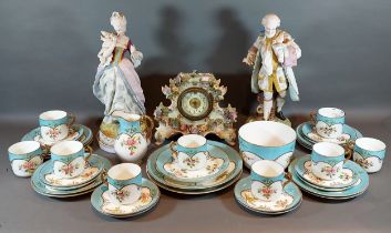 A pair of 20th Century bisque figures together with a foliate encrusted clock and an English tea