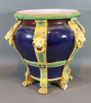 A Minton Majolica jardiniere with lion mask ring handles upon a Cobalt blue ground, 28cms tall