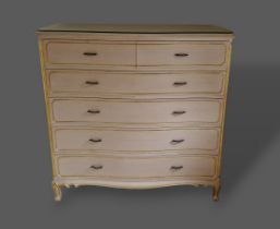 A cream painted bedroom suite, comprising of a chest with four short and three long drawers, a